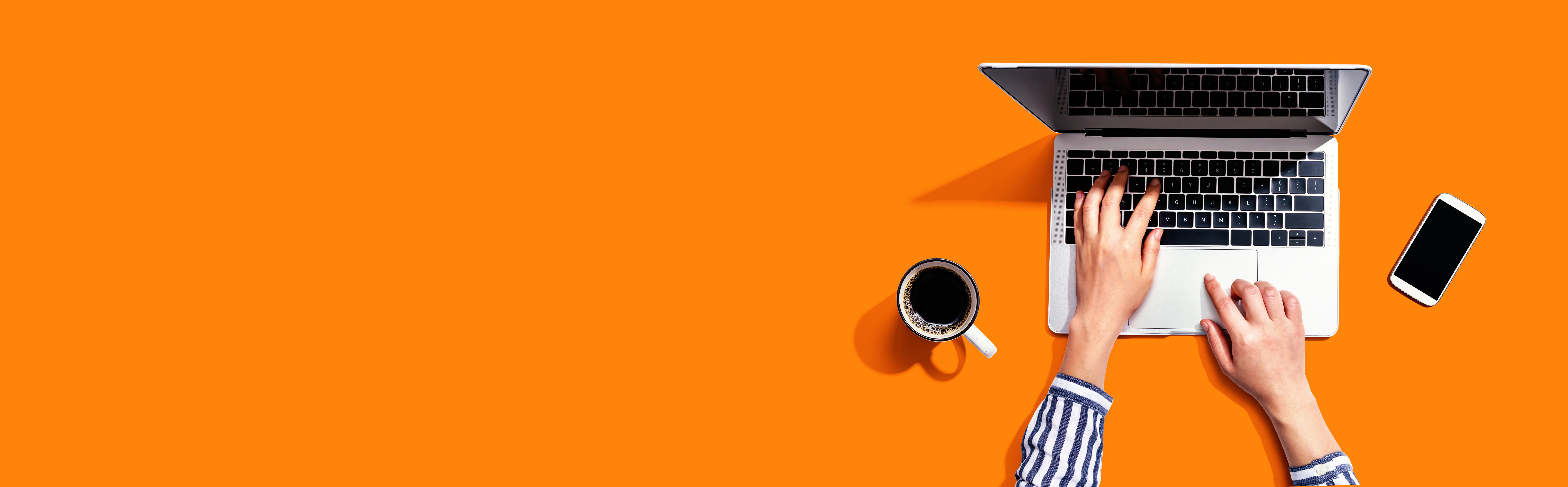 Open laptop on orange background